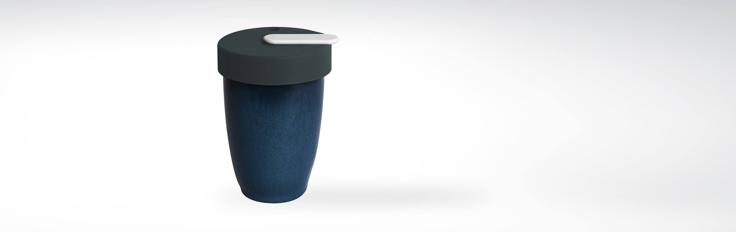 Ein dunkelblauer Kaffeebecher aus Keramik mit einem abnehmbaren schwarzen Silikondeckel und einem weißen Trinkverschluss, ideal für umweltbewusste Kaffeetrinker.