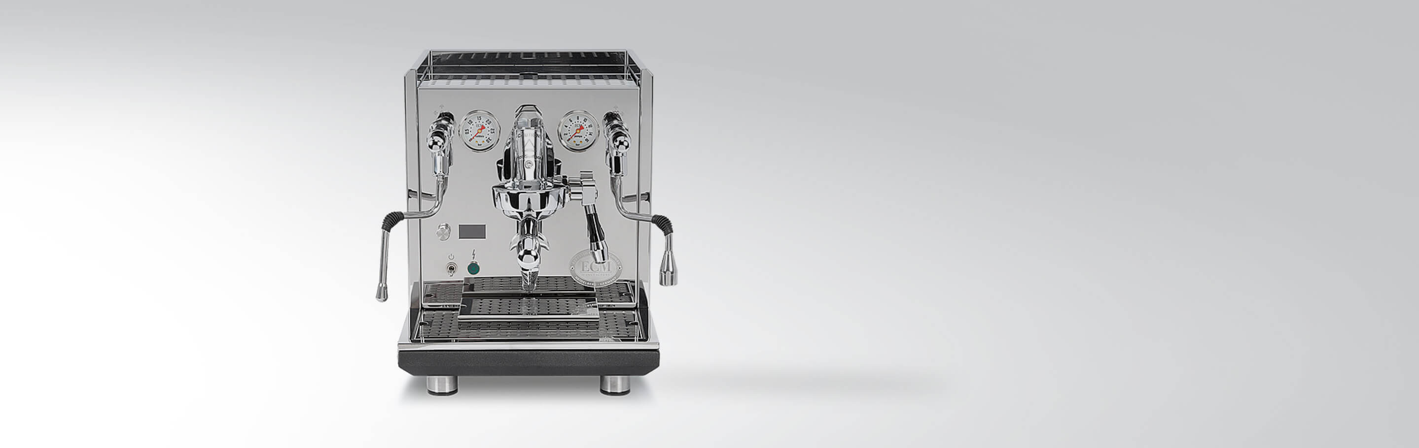 Ansicht einer professionellen Espressomaschine aus Edelstahl mit Manometern und Bedienelementen auf weißem Hintergrund