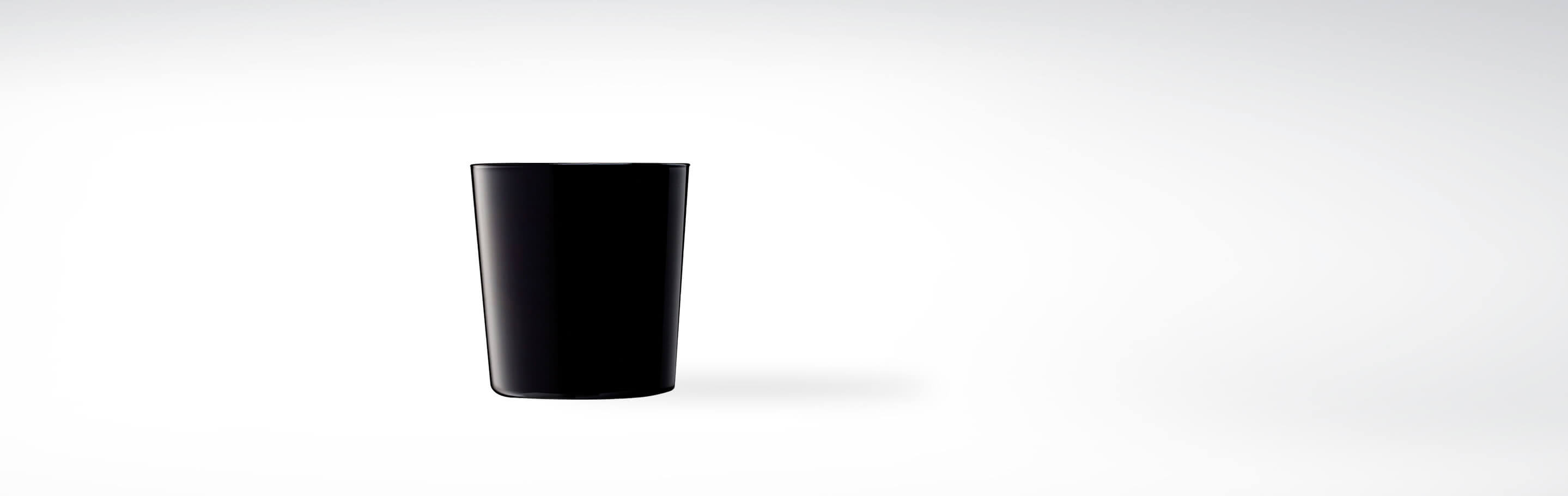 Ein einfacher, schwarzer Becher aus Keramik auf weißem Hintergrund