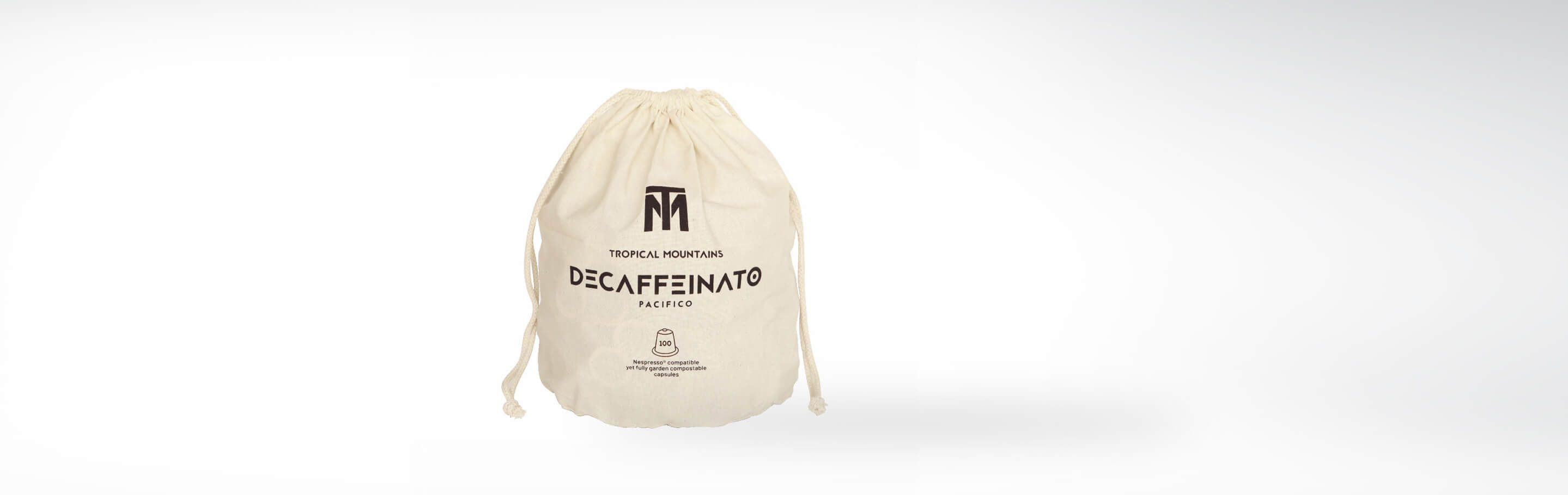 Beutel mit Tropical Mountains Decaffeinato Pacifico entkoffeinierten Kaffeekapseln, zu 100% biologisch abbaubar und Nespresso-kompatibel.