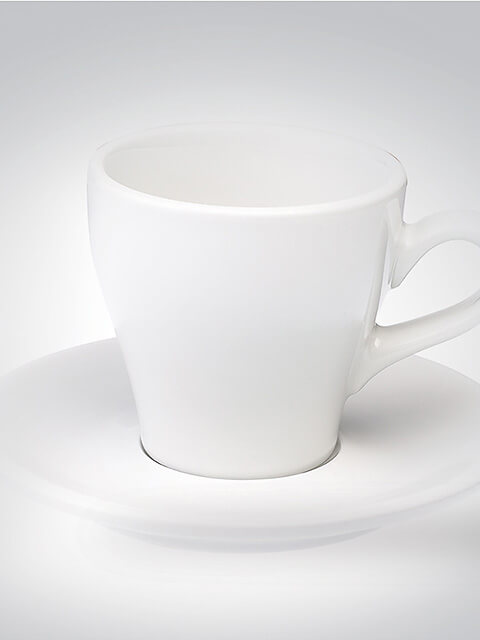 Weiße Porzellantasse auf passender Untertasse, minimalistisches Design