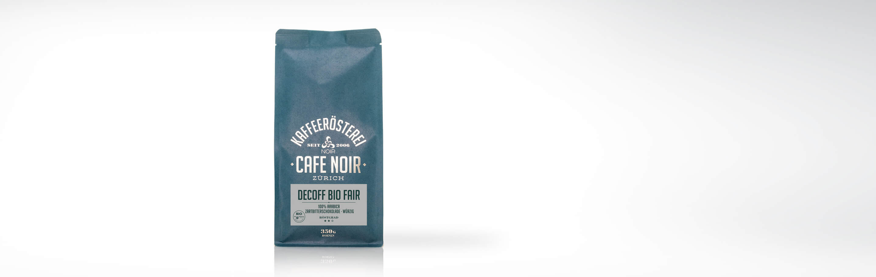 Verpackung des Cafe Noir Decoff Bio Fair Kaffees aus Zürich mit 100% Arabica, Geschmack von Zartbitterschokolade und würziger Note.