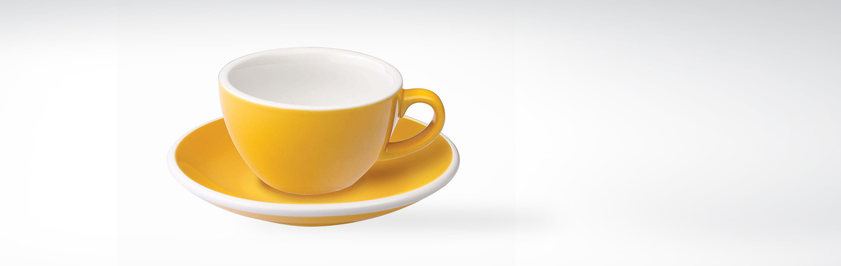 Gelbe Keramiktasse mit passender Untertasse, perfekte Wahl für Ihren morgendlichen Kaffee.