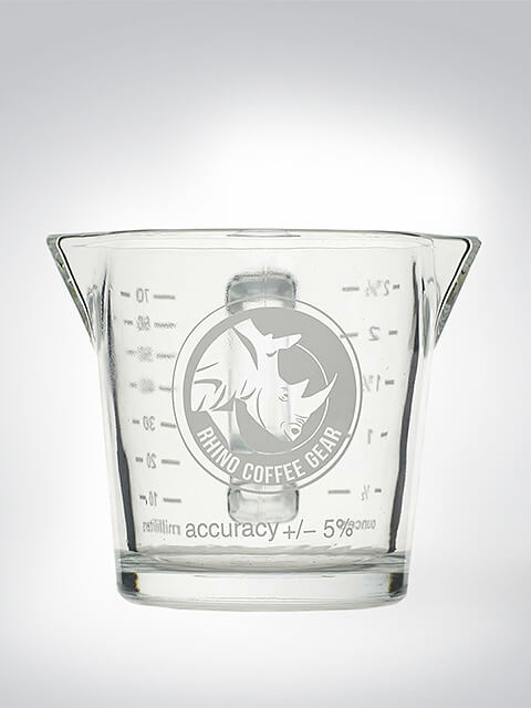 Glas-Messbecher von Rhino Coffee Gear mit Skalierung und Logo, ideal für präzises Abmessen von Flüssigkeiten.